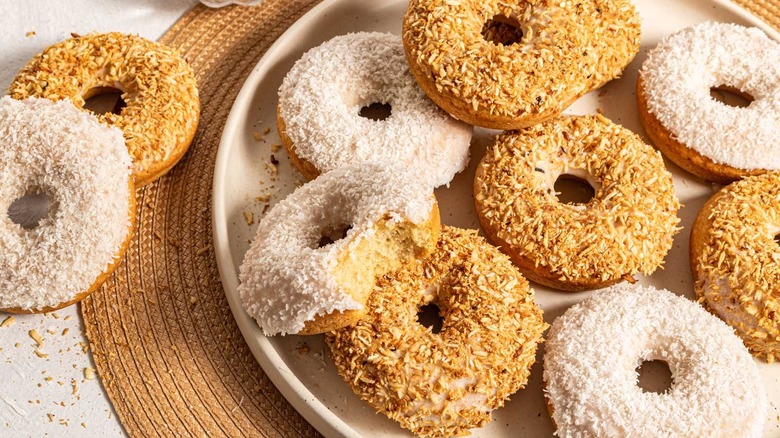 Plate with coconut baked donuts with two on the side