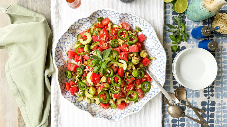 Deconstructed watermelon salad in serving bowl on table