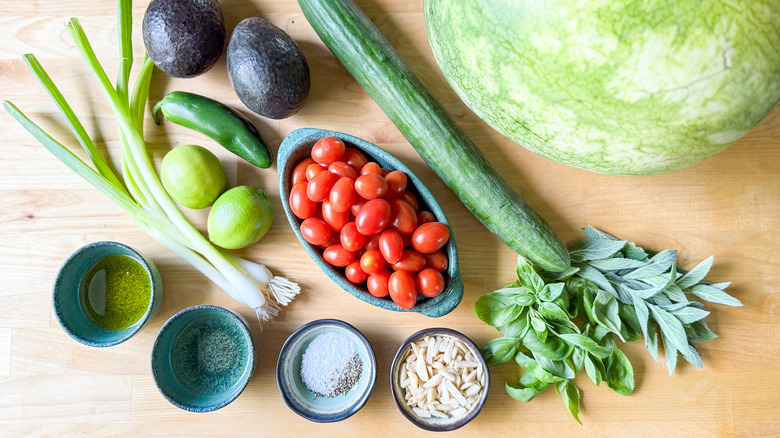 Deconstructed watermelon gazpacho salad ingredients on cutting board