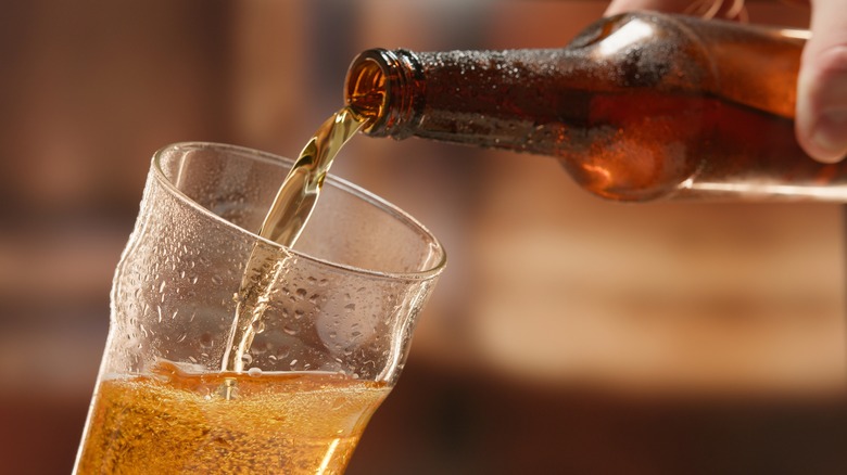 Beer poured from a bottle into a glass