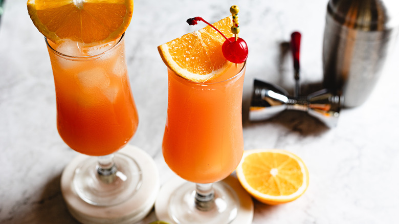 two hurricane cocktails on marble coasters