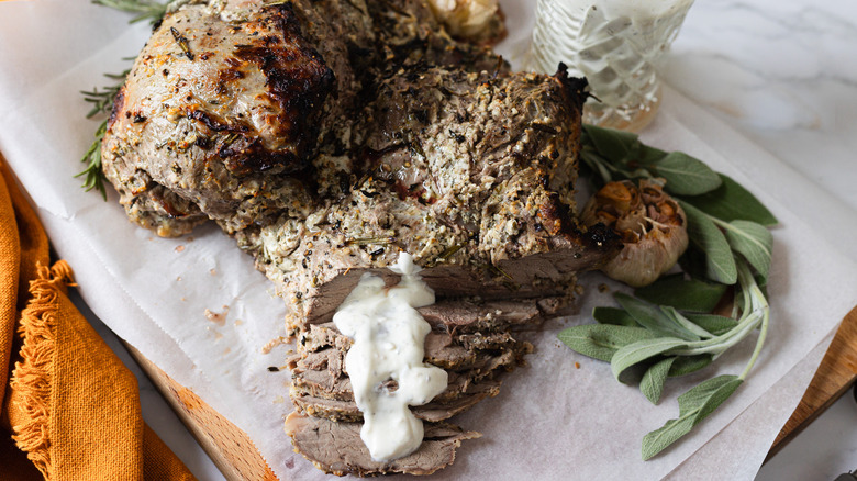 Roasted leg of lamb, sliced at the end, with sage and sauce