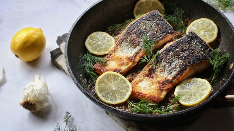 skillet of salmon, lemons, and dill