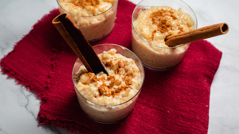 Three servings of rice pudding on red napkin