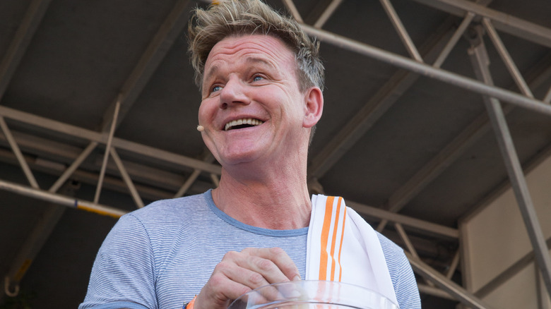 Gordon Ramsay smiling with kitchen towel