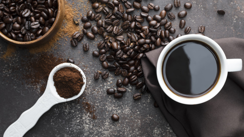 Overhead view of black coffee and beans 