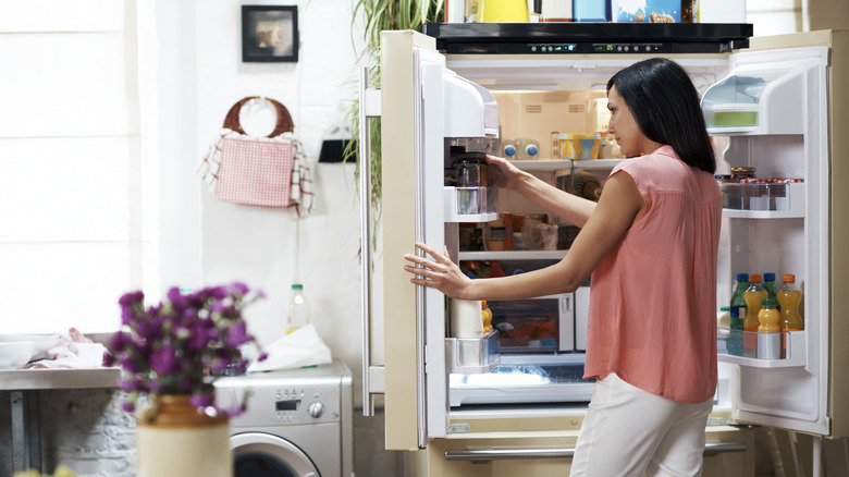 Woman organizing the fridge