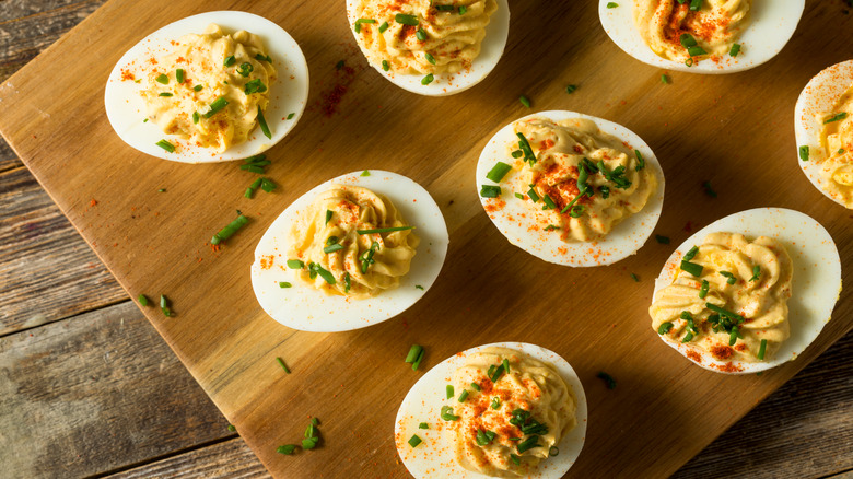 Deviled eggs on wooden board