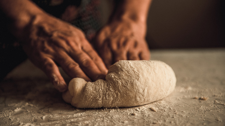 Hands kneading dough