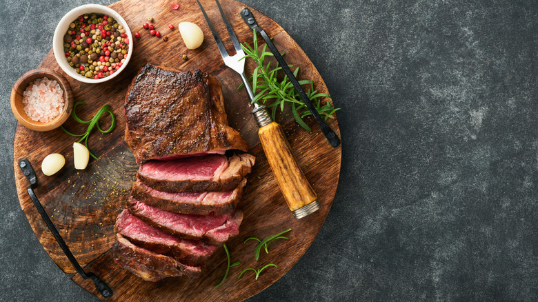 Sliced steak on cutting board