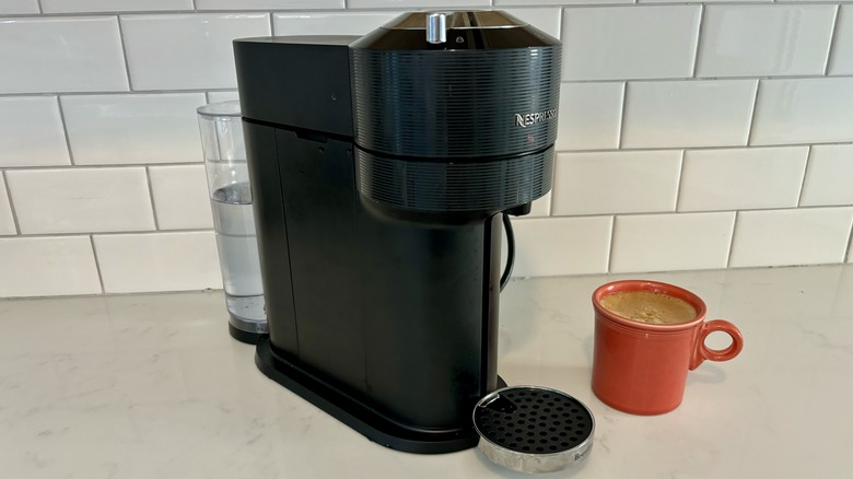 Nespresso machine and red coffee cup