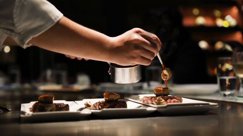 chef plating food at fine dining restaurant