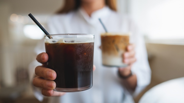 Woman with two iced coffees