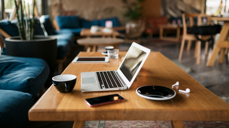 Laptop and coffee cup on table.