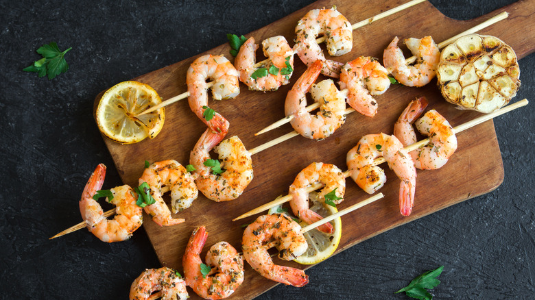 grilled shrimp skewers on a board