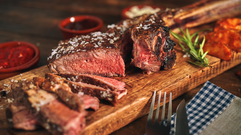 Cut of rare steak on a wooden board