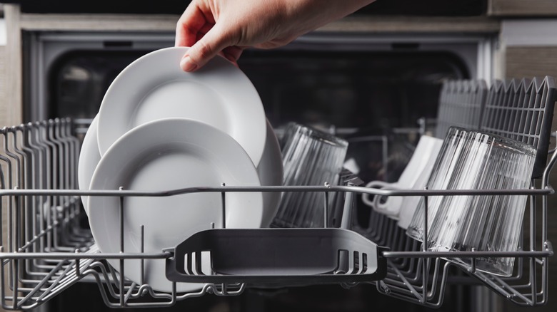 Person unloading dishwasher