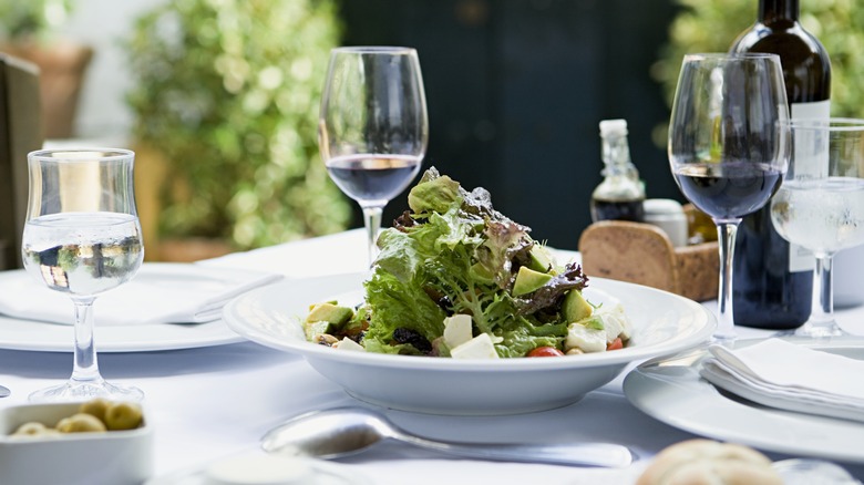 Fancy table setting with a salad in the center