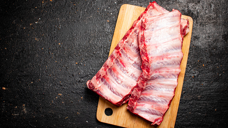 Raw pork ribs on board