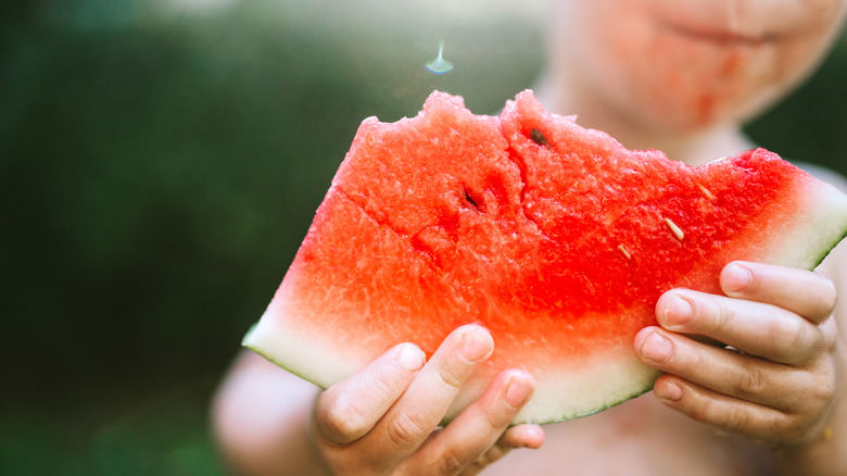 Small child eating watermelon