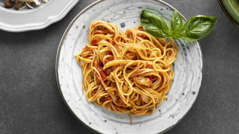 Spaghetti and basil on plate