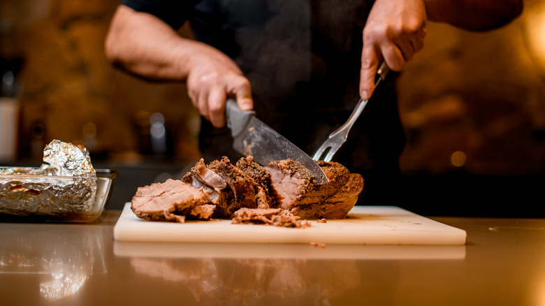 man cutting meat