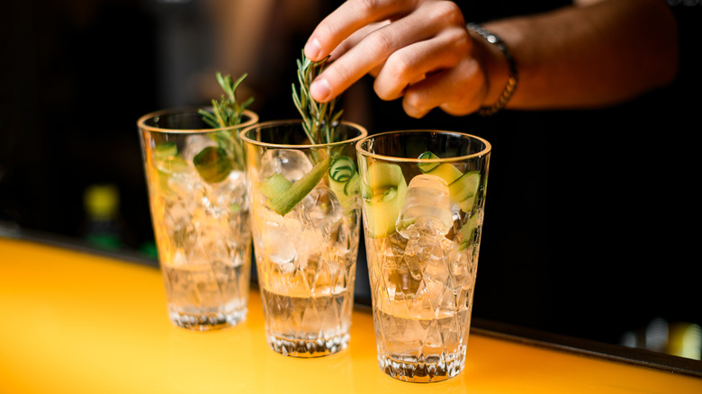 Bartender placing thyme in glass