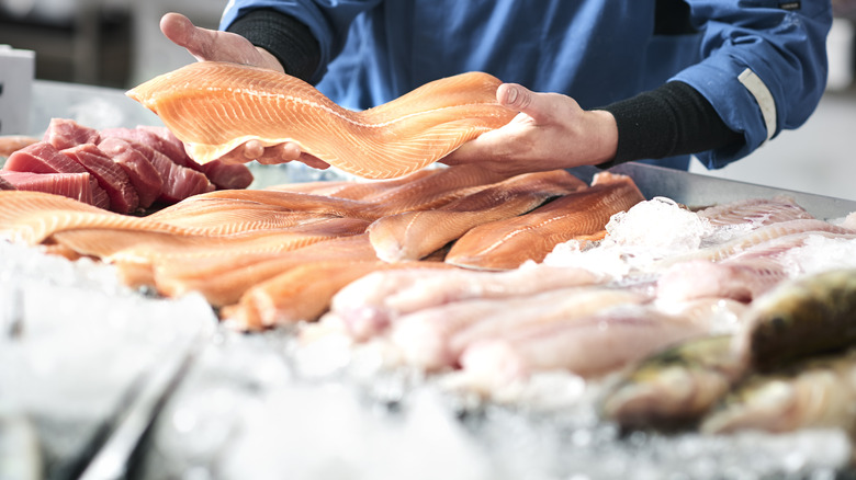 fishmonger with fresh fish 