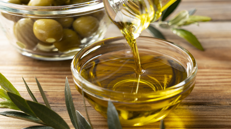 Olive oil pouring into bowl