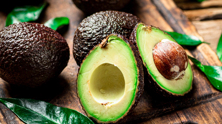 Closeup of whole and cut avocados