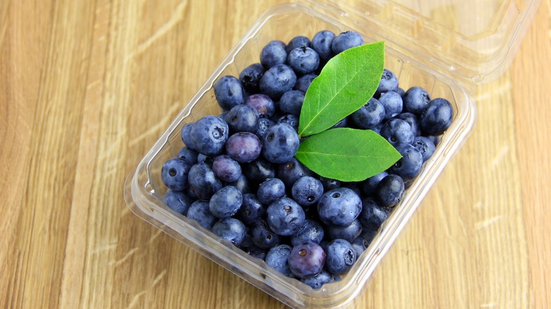 Pint of blueberries on wood