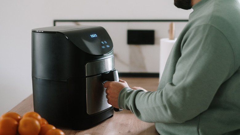 Man using air fryer