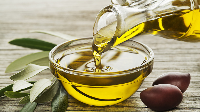 pouring olive oil into bowl