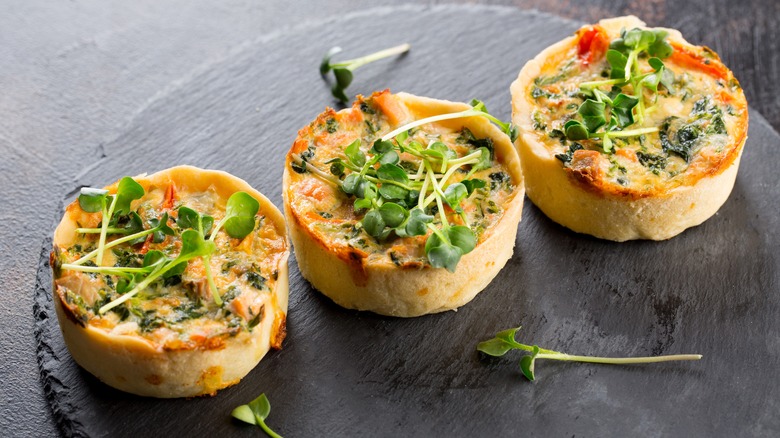 three mini quiches with garnish