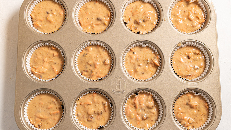 Baking tin with carrot cupcakes batter