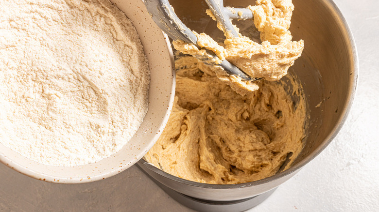 flour pouring into cookie dough