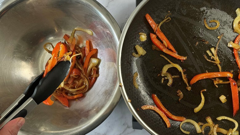 hand holding peppers and onions